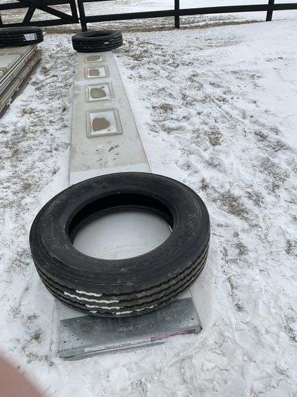 2-24 foot garage door panels with windows. Tires - Legacy Auction Company