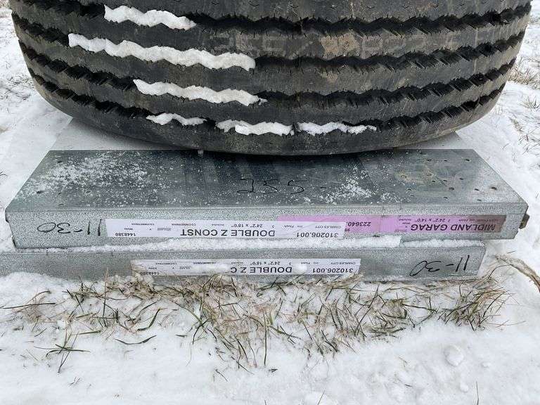 2-24 foot garage door panels with windows. Tires - Legacy Auction Company