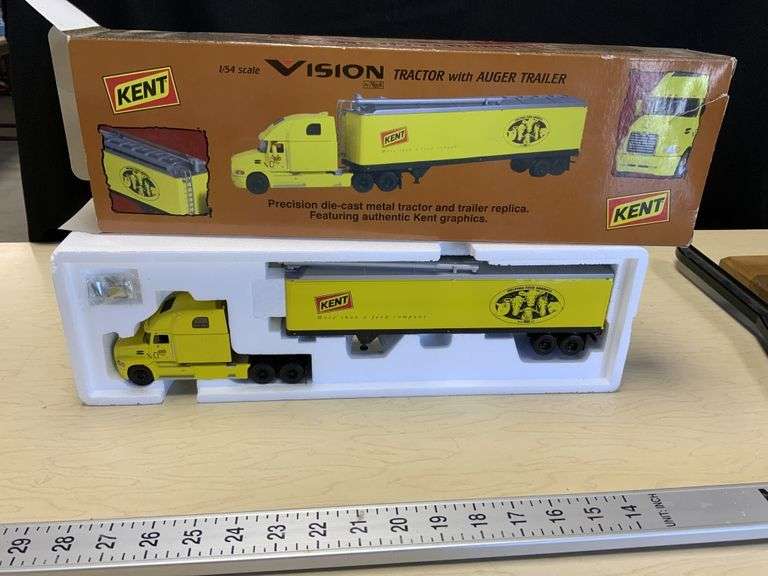Kent Vision tractor with auger trailer Legacy Auction Company