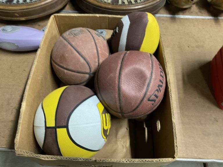 Basketballs, football and baseballs Legacy Auction Company