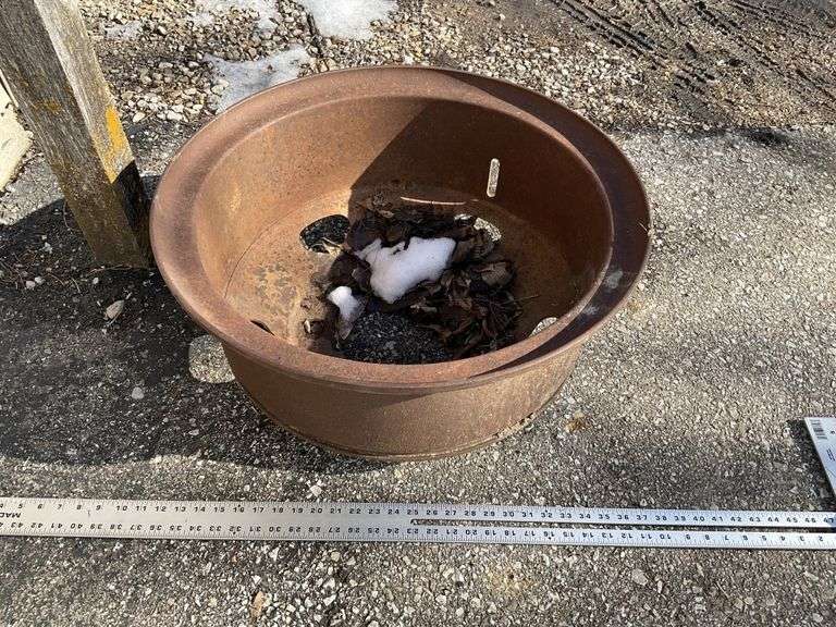 Truck rim/Fire pit Legacy Auction Company