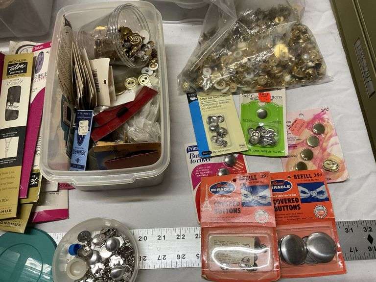 Buttons and zippers etc. Legacy Auction Company