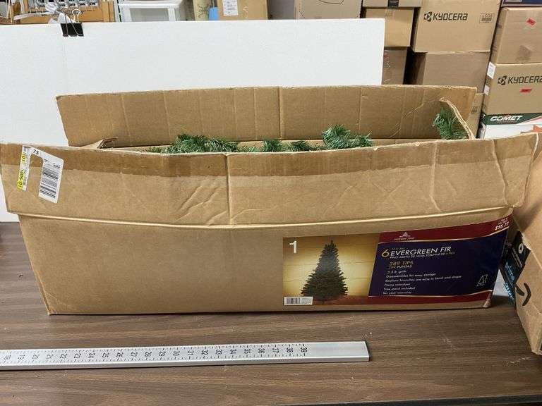 6 foot Christmas tree and box of ribbons Legacy Auction Company