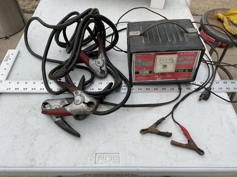 Kmart battery charger and one set of jumper cables Legacy Auction Company
