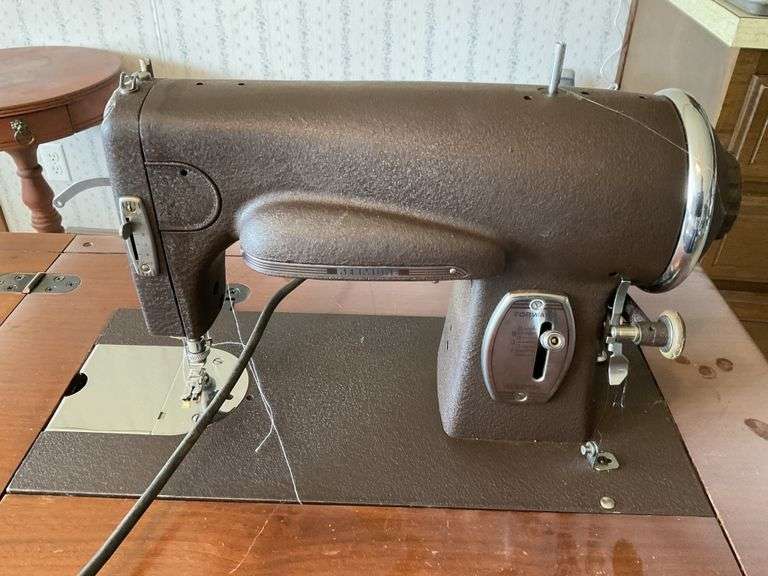 Antique Kenmore sewing machine and with Legacy Auction Company