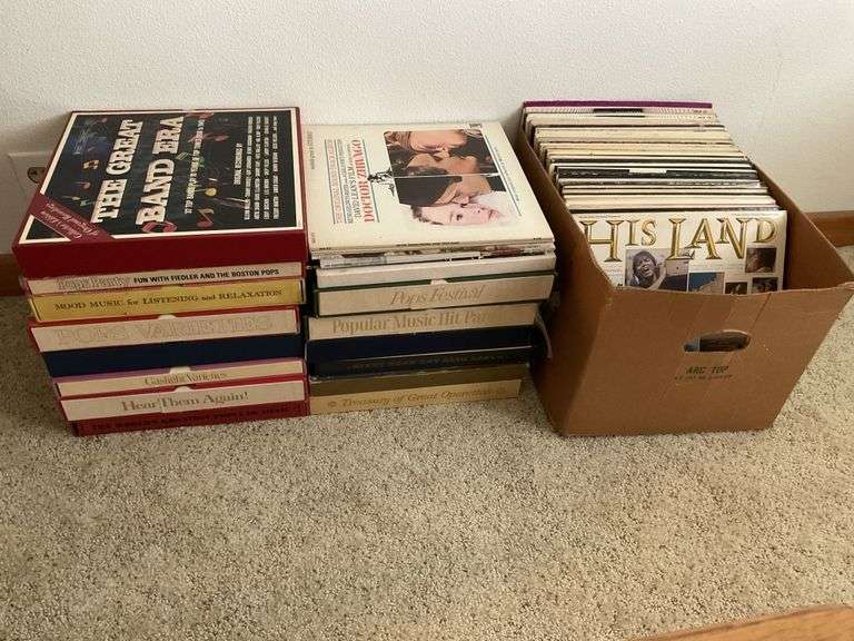 3 stacks of record albums Legacy Auction Company