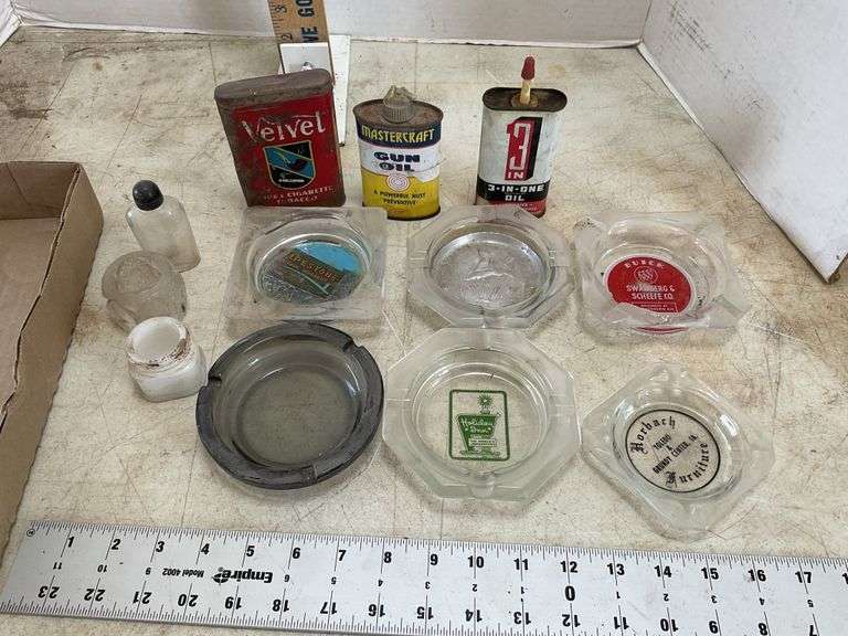 Ashtrays, a couple of chips, tins, etc. Legacy Auction Company