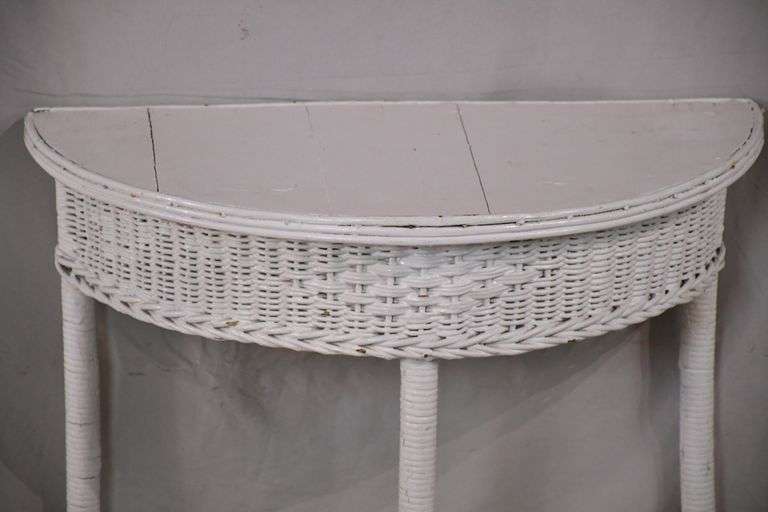 Small white wicker half round console table; 793208 R.H. Lee & Co