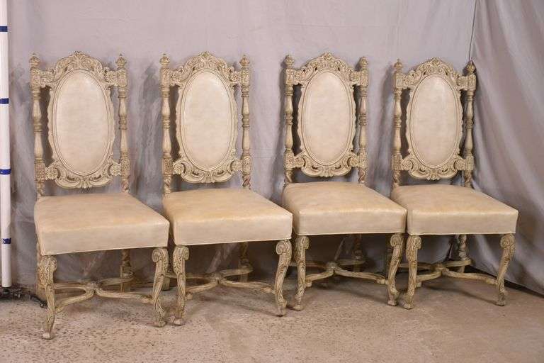 Set of 4 carved offwhite dining chairs with ornate "x" stretcher bases