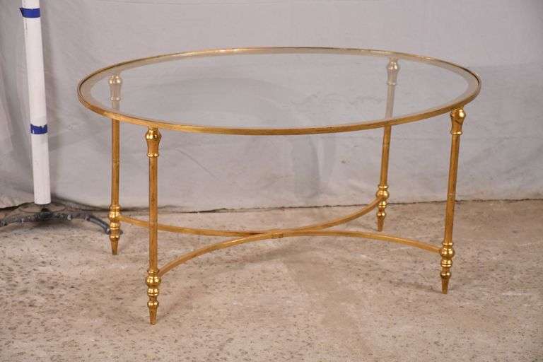 Oval gold metal coffee table with glass top; 12750007 R.H. Lee & Co