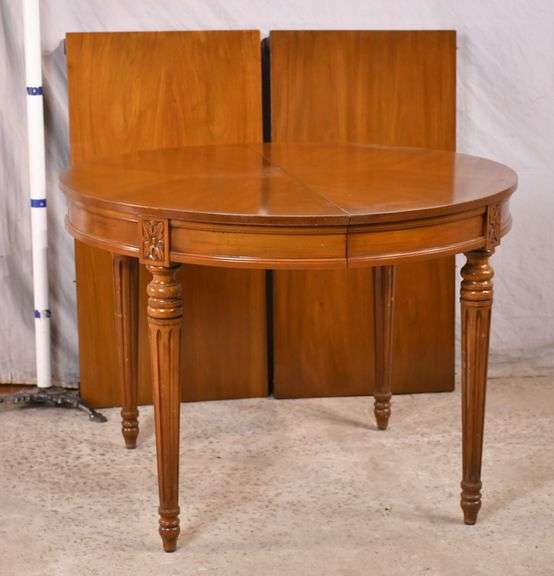 Round French style dining table with fluted legs and 2 skirted leaves