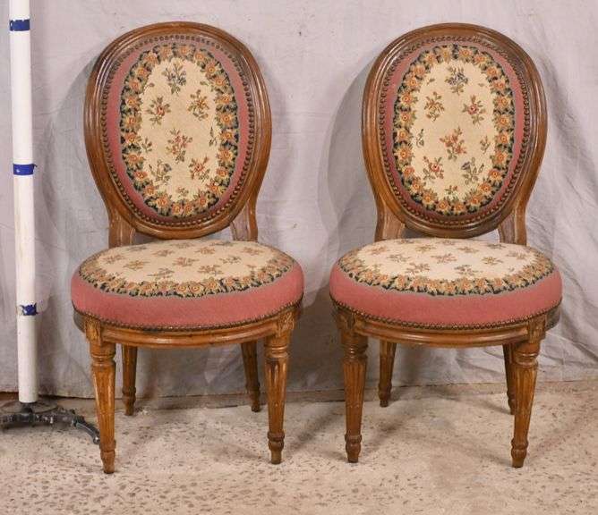 Pair of carved French style accent chairs with needlepoint fabric; 697