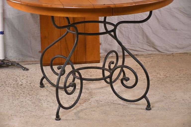 Ethan Allen round dining table with ornate metal base and 1 skirted