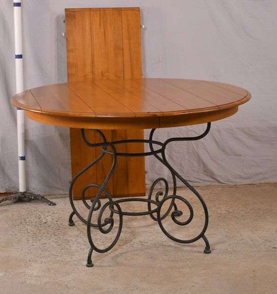 Ethan Allen round dining table with ornate metal base and 1 skirted