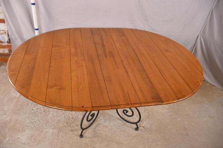 Ethan Allen round dining table with ornate metal base and 1 skirted