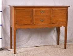 Suter's walnut huntboard with tapered legs; 200-228