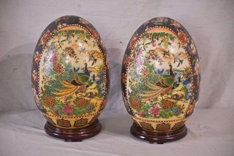 Pair of Royal Satsuma hand painted ceramic eggs on wooden stands; 336