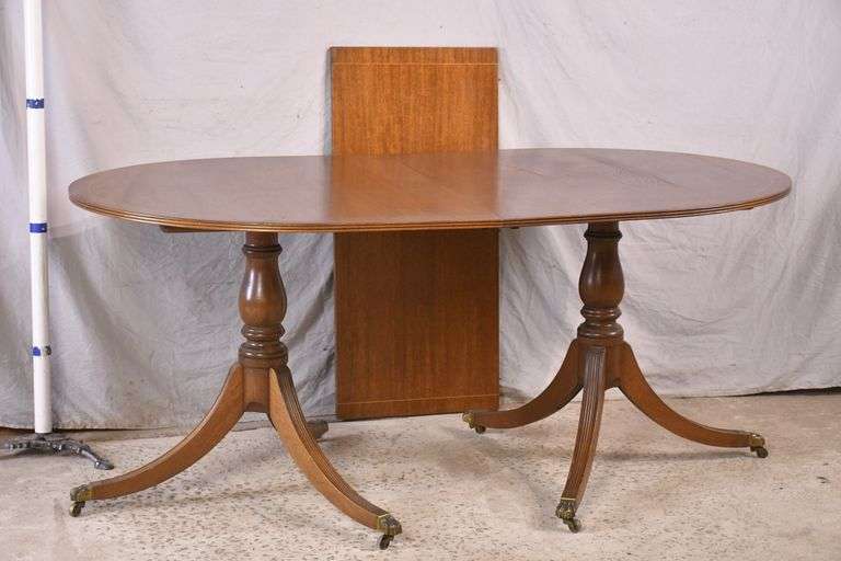 Oval inlaid mahogany double pedestal dining table with 1 leaf; 13600