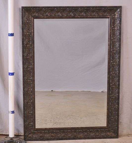 Large beveled mirror with ornate dark finish frame; 1116198 R.H. Lee & Co. Auctioneers