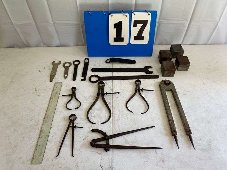 4) metal blocks, 7) wrench tools, 1) large Geometry compass, (1) medium geometry compass, 3) Wood Lathe Calibers, 1) spreader wood Lathe Caliber