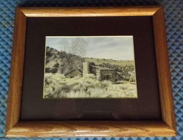 LOT 71Jon Crane framed print Log cabin in grass with stone chimney