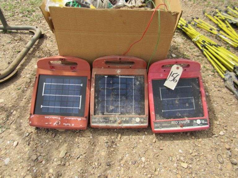 3 RED SNAPPER SOLAR FENCE CHARGERS AND BOX FULL OF ELECTRIC FENCE
