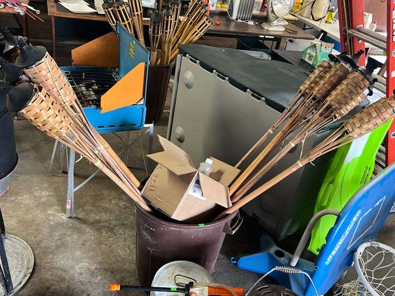 (10) Tiki torches with citronella torch fuel 3/4 of a gallon and patio