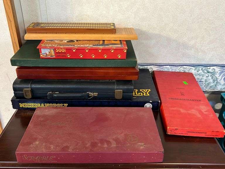 Assorted board games including Cribbage master, scrabble, Michiganopoly, Chess, four track
