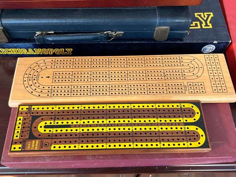 Assorted board games including Cribbage master, scrabble, Michiganopoly, Chess, four track