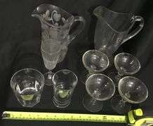 Clear, pattern glass pitchers and stemware assortment