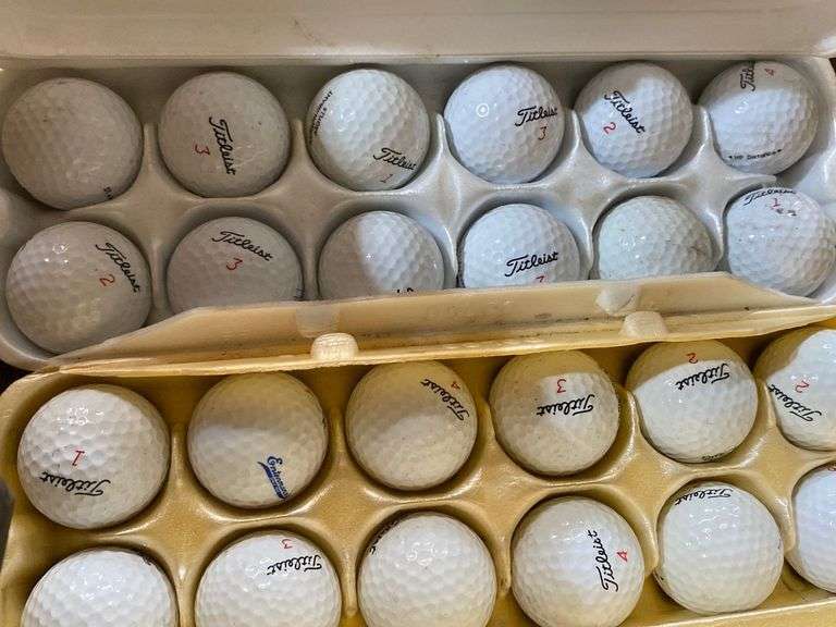 Gulf tees, canister of golf balls, egg cartons of golf balls Metzger