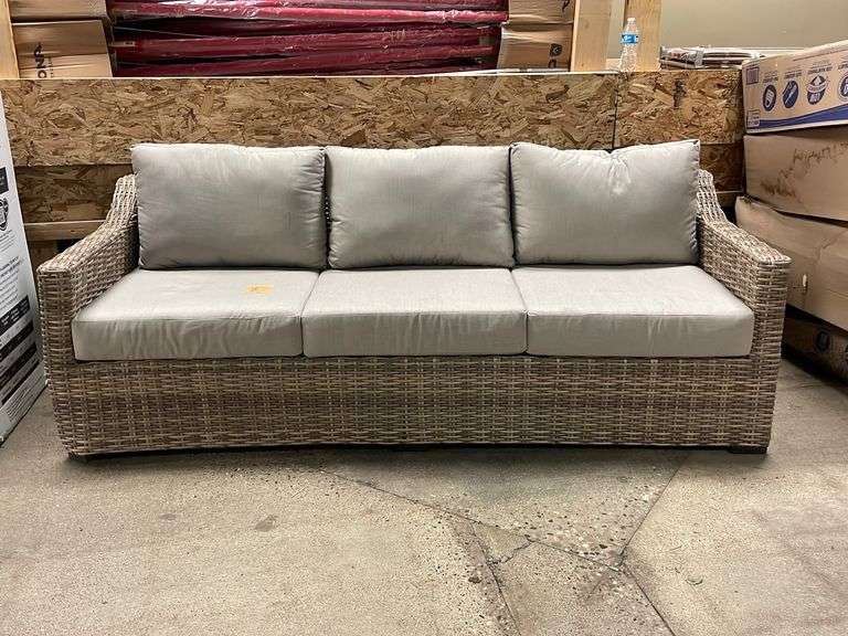 Plastic wicker outdoor couch with tan cushions (damaged corners) 82”w