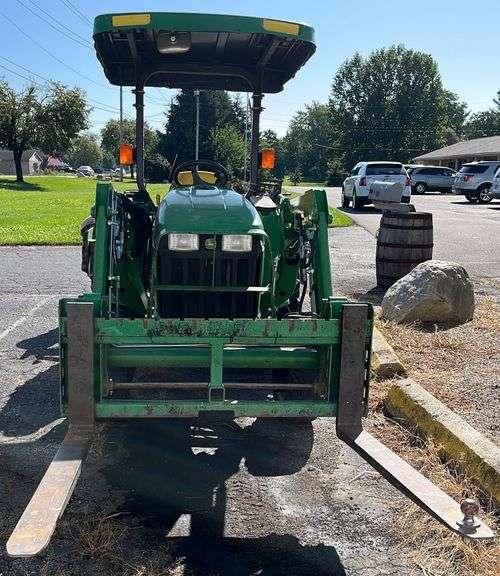 John Deere 3038E tractor and loader with pallet forks and material