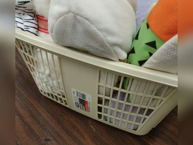 Laundry basket with stuffed animals.