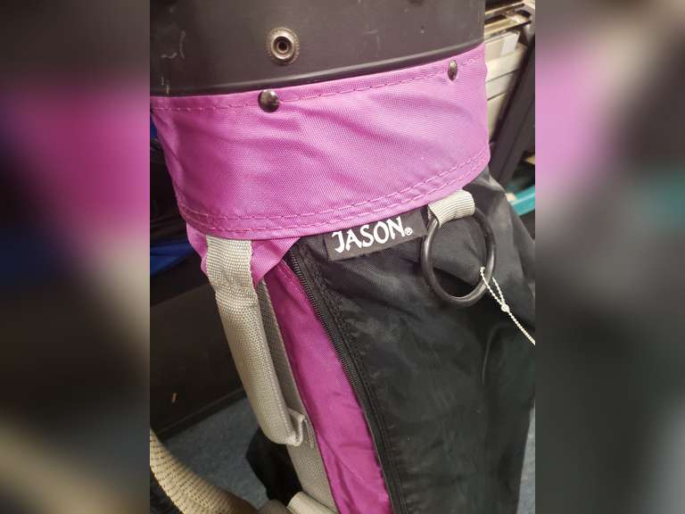 Pure Spin golf clubs and a purple Jason golf bag.
