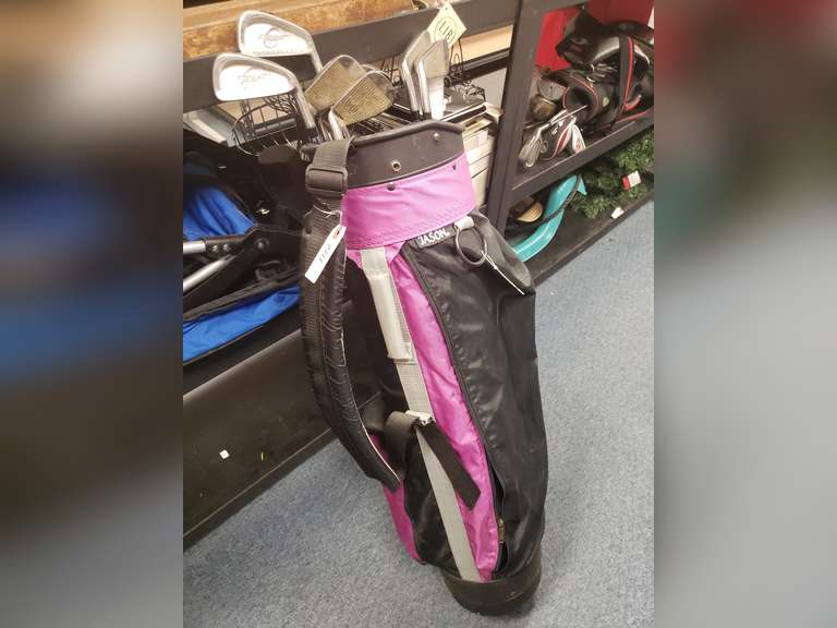 Pure Spin golf clubs and a purple Jason golf bag.