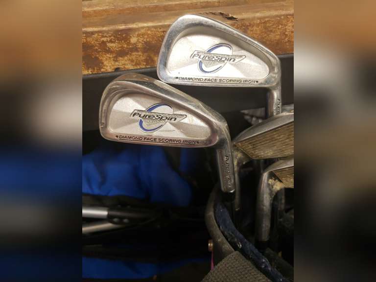 Pure Spin golf clubs and a purple Jason golf bag.