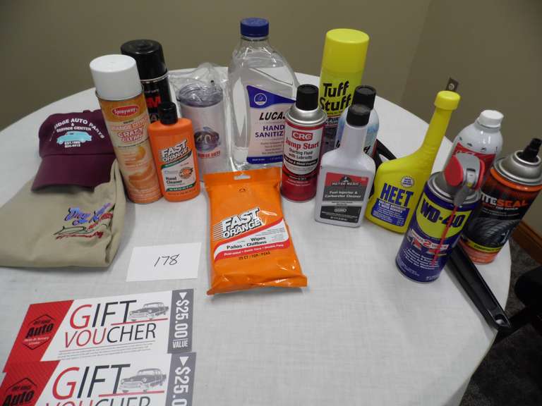 Tote of auto parts items and 2 25 Dry Ridge Auto Parts gift