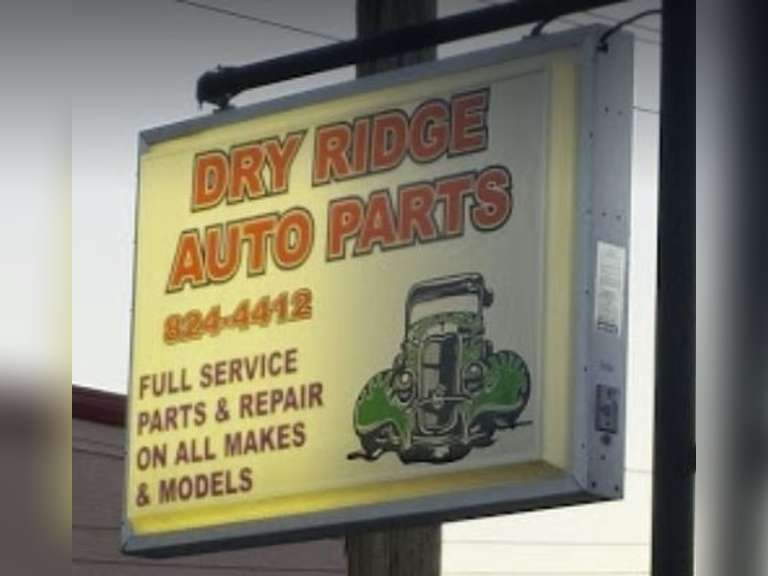 Tote of auto parts items and 2 25 Dry Ridge Auto Parts gift