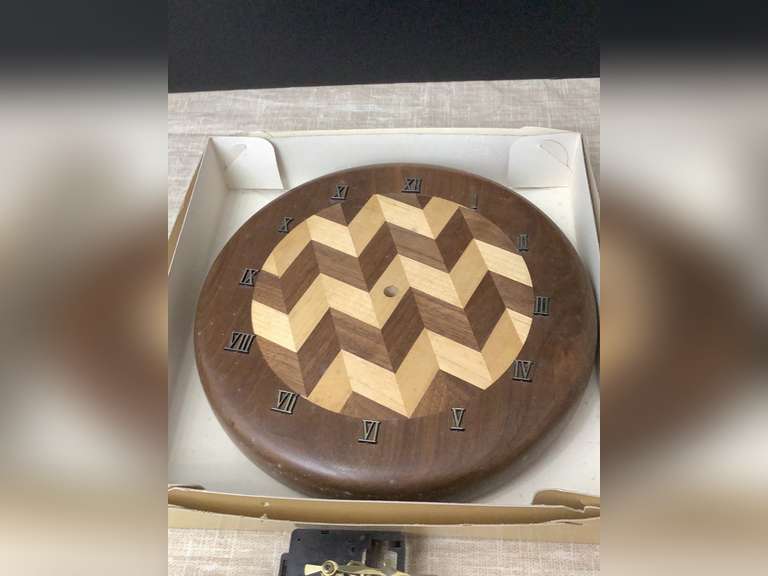 Battery operated wood wall clock, 11” in diameter. Hands and battery