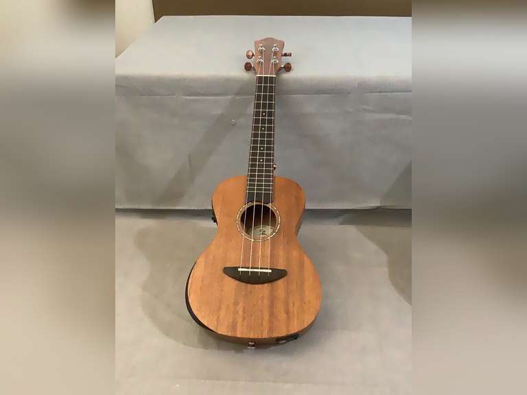 Donner Ukulele guitar with Bass, Middle, Treble and volume. Stickers on