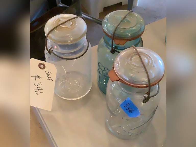 3 Ball jars with glass lids & bails. 2 clear and 1 blue.