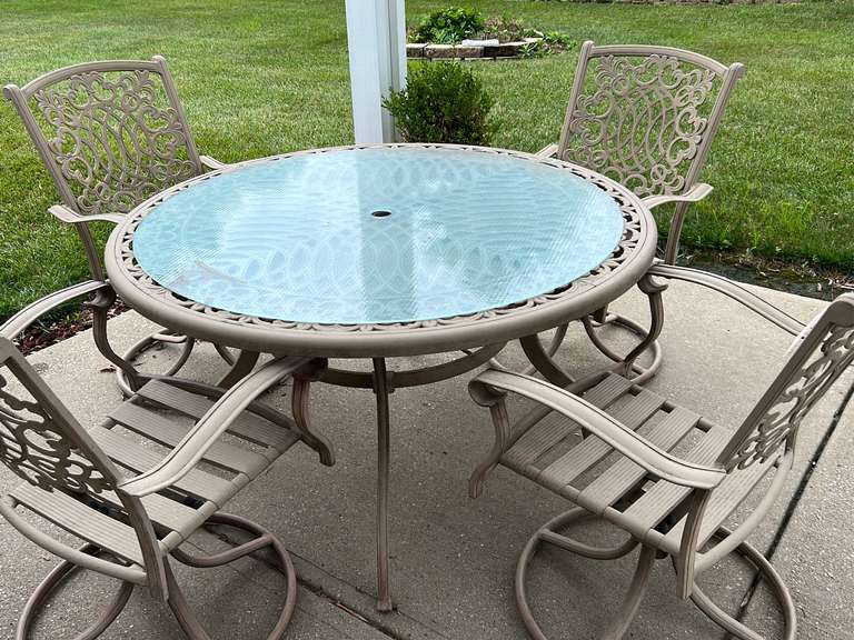 50 Inch round metal patio table and four swivel rockers Northern