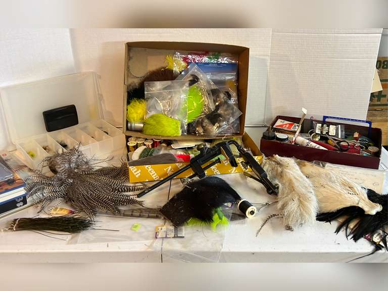 Box lot full of fly tying supplies. Fly tying books and a fly tying vise.