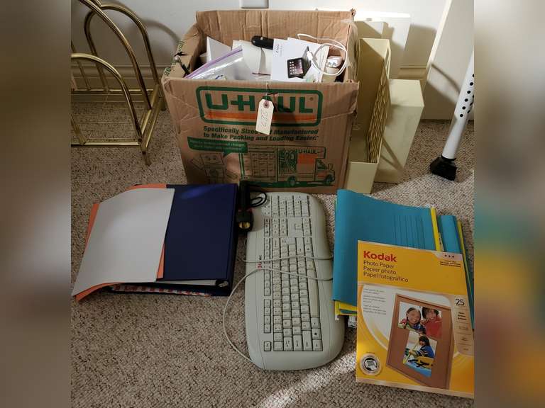 Box full of miscellaneous office supplies and accessories,  keyboard, binders, hanging folders