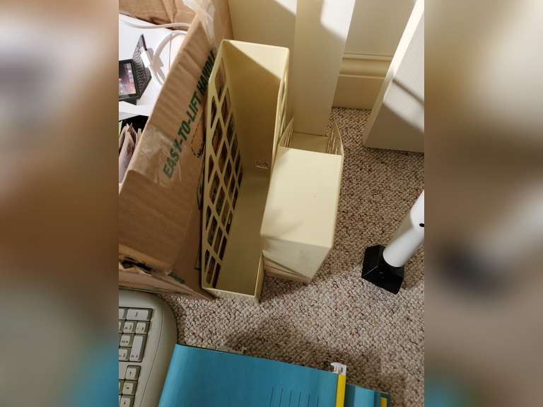 Box full of miscellaneous office supplies and accessories,  keyboard, binders, hanging folders