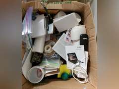 Box full of miscellaneous office supplies and accessories,  keyboard, binders, hanging folders
