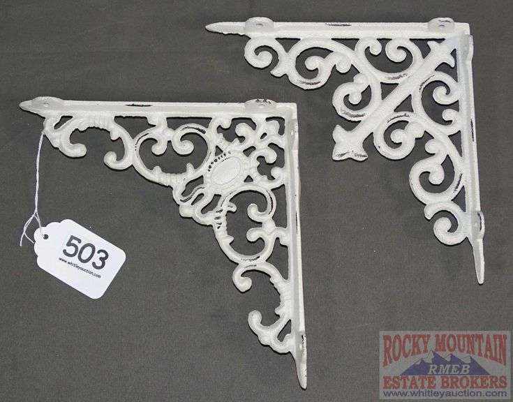 2 White Cast Iron Shelf Brackets. Rocky Mountain Estate Brokers Inc.