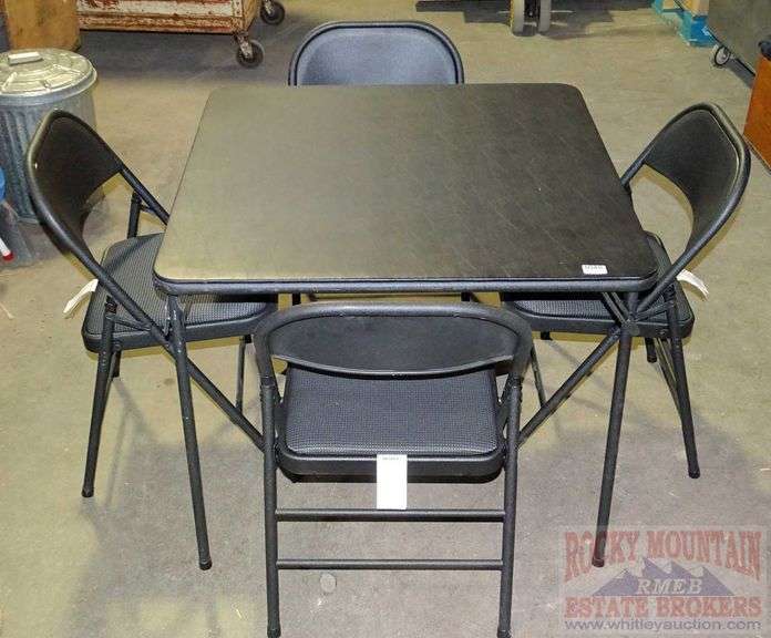 Nice Cosco black folding card table with 4 padded folding chairs. All