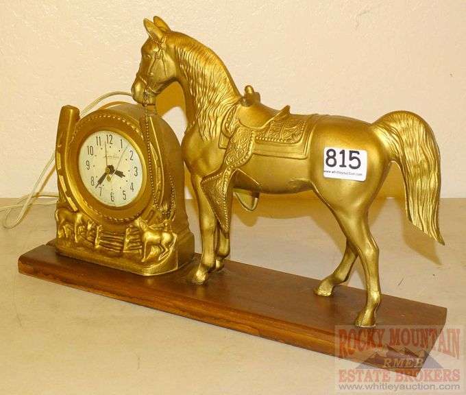Neat vintage Lanshire horse clock with wooden base. Rocky Mountain Estate Brokers Inc.